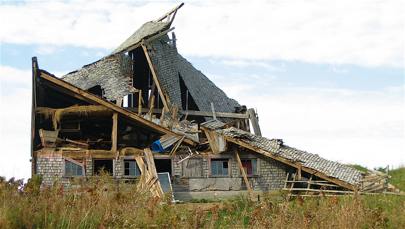 a shot of a run-down house on a hill